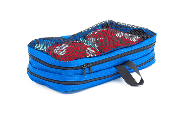 A filled and zipped closed Island (blue) Aether Small Laundry Aeronaut 30 Packing Cube showing the mesh side.